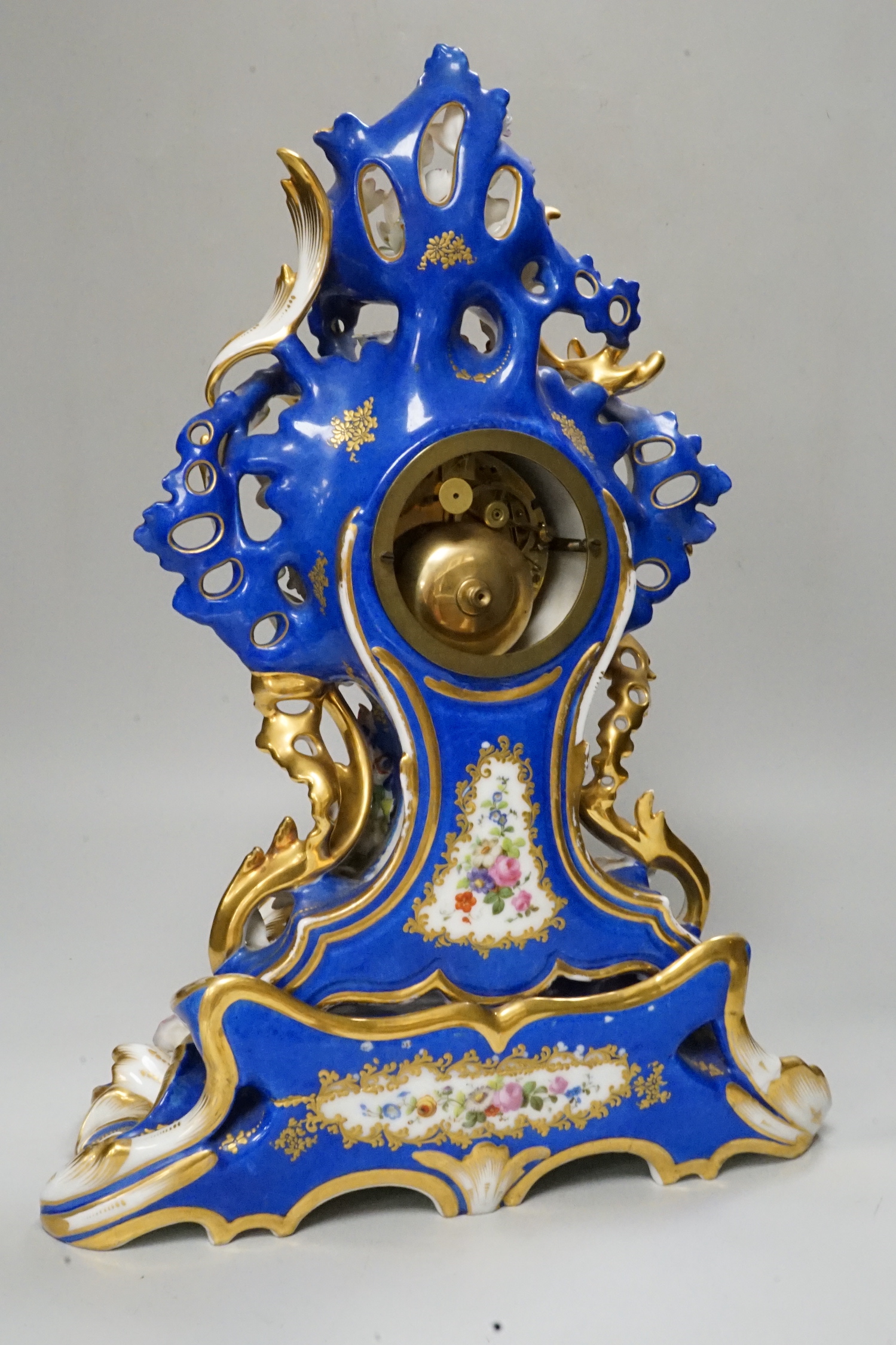 A mid 19th century French porcelain mantel clock and stand, probably Jacob Petit, 43cm tall